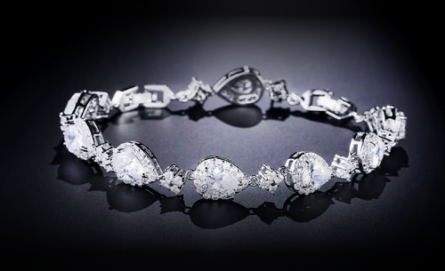 Silver bracelet with clear gemstones on a black background